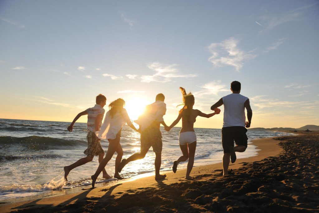 people group running on the beach Stock Free