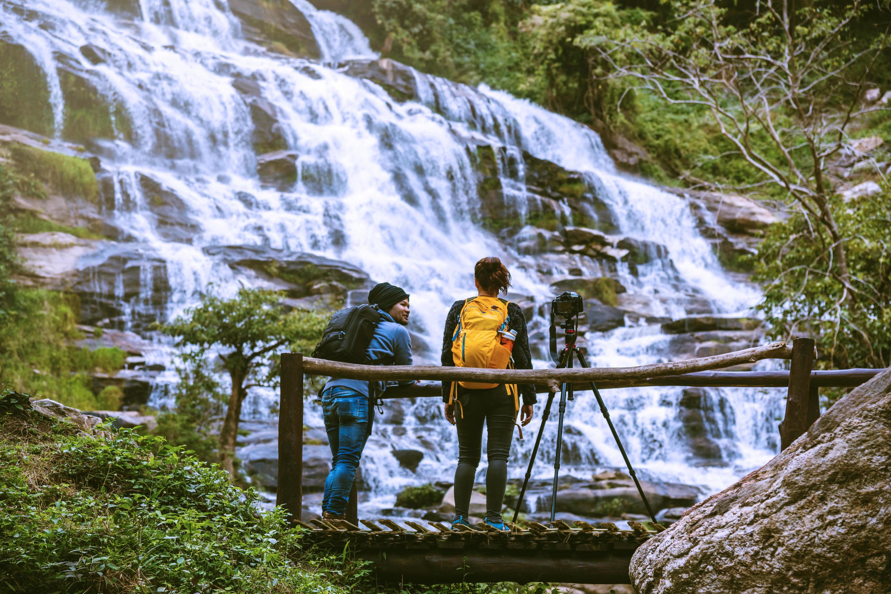 couples travel relax to photograph the waterfalls beautiful. In the winter. at the waterfall mae ya chiangmai in thailand. travel nature. summer Stock Free