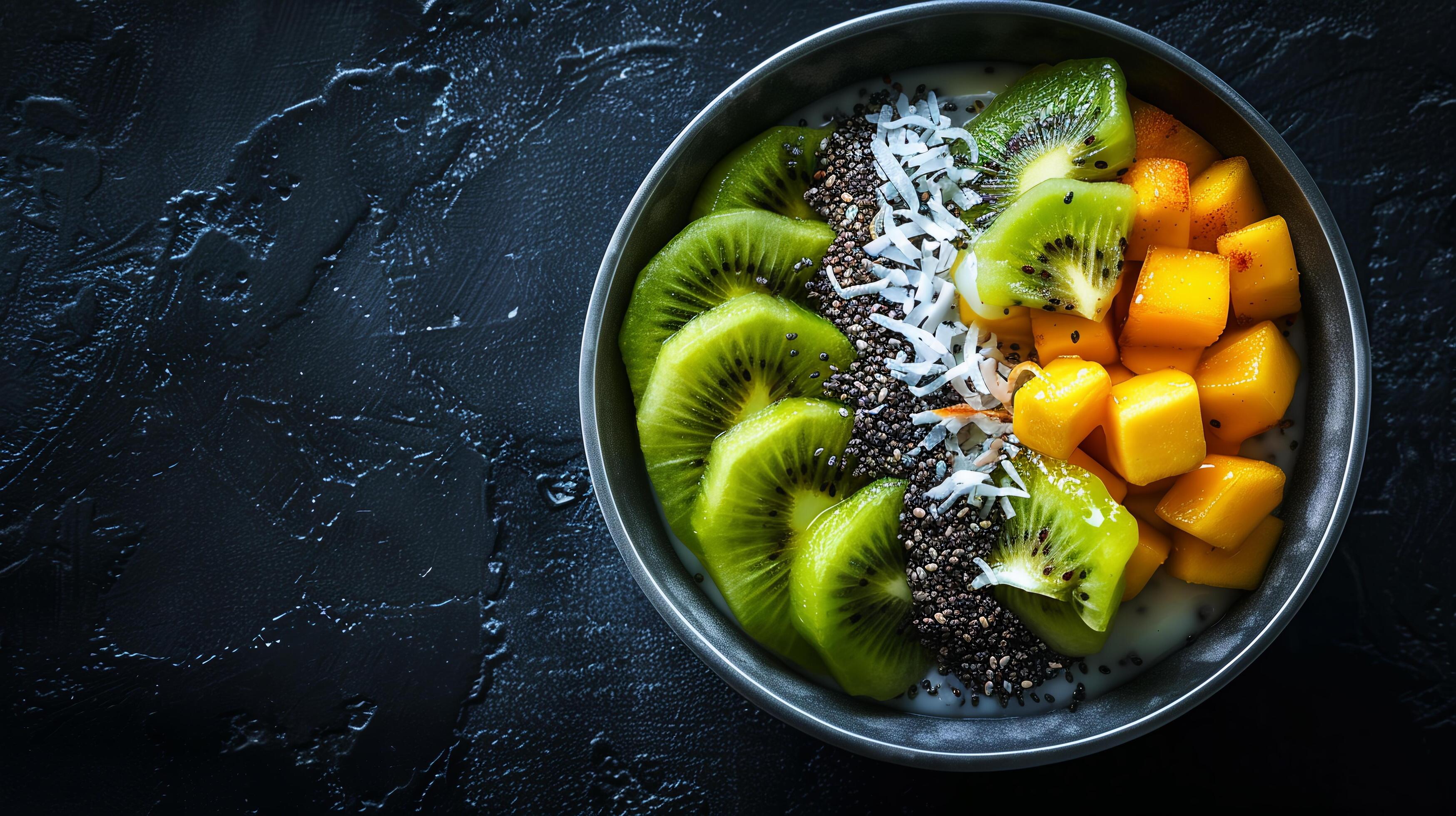 Chia seed pudding topped with sliced kiwi, mango, and a sprinkle of toasted coconut flakes. Stock Free