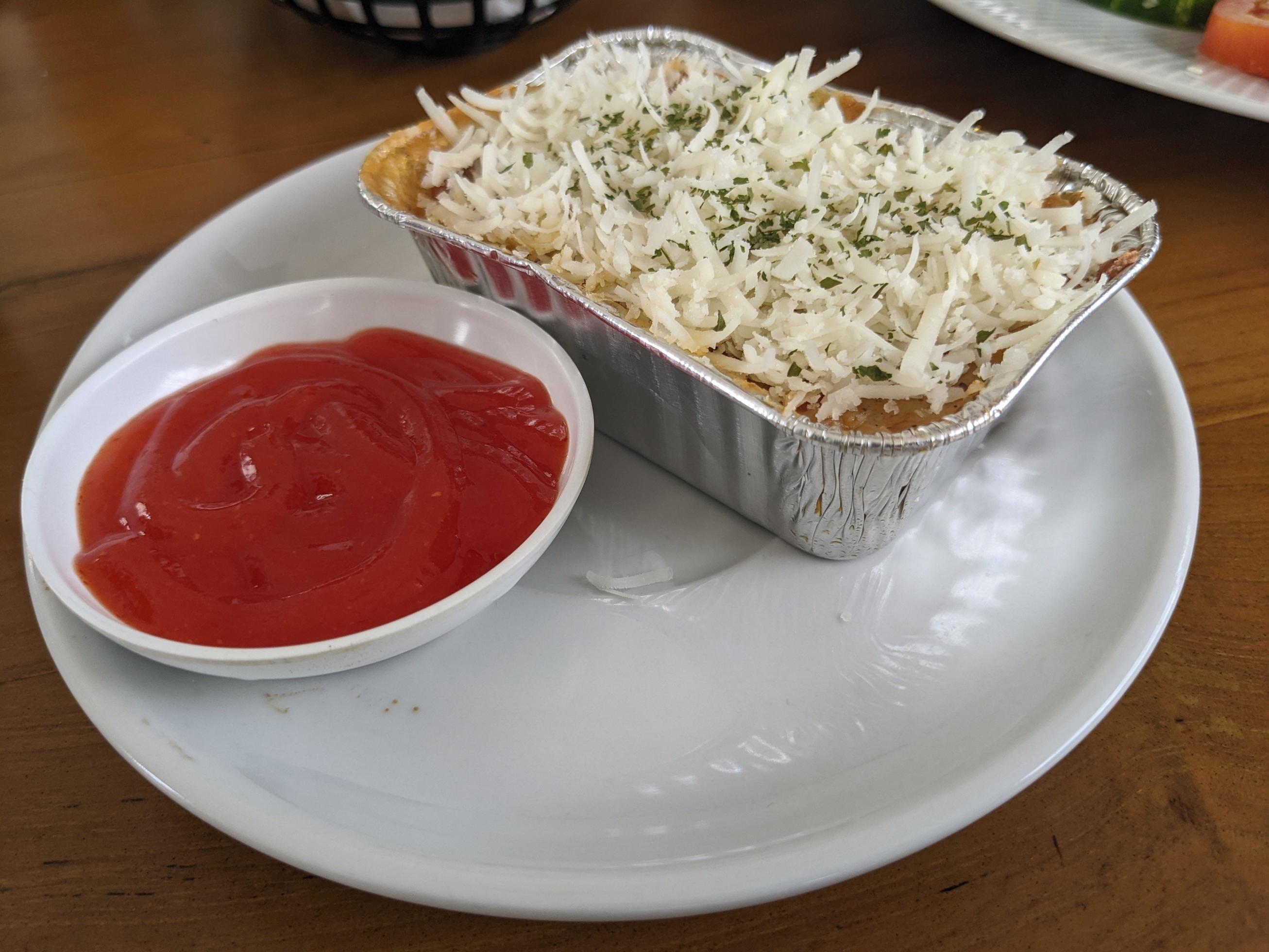 Cedar Cheese and mozzarella on the roasted beef lasagna with chili sauce. The photo is suitable to use for food background, poster and food content media. Stock Free