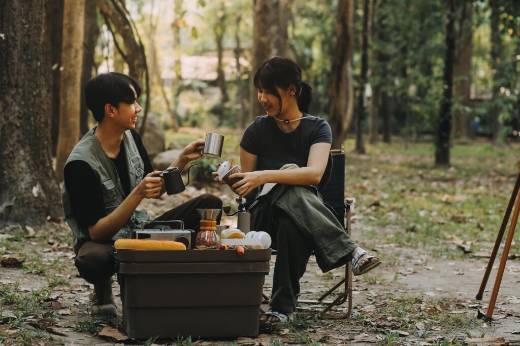 Asian couple sweet in tent inside on they camping trip, traveller relax and sleep togather in out door and camping trip Stock Free