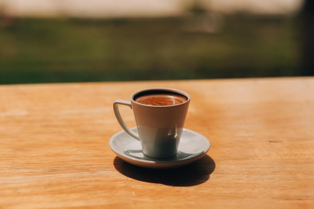 Closeup of coffee cup on table in empty corporate conference room before business meeting in office Stock Free