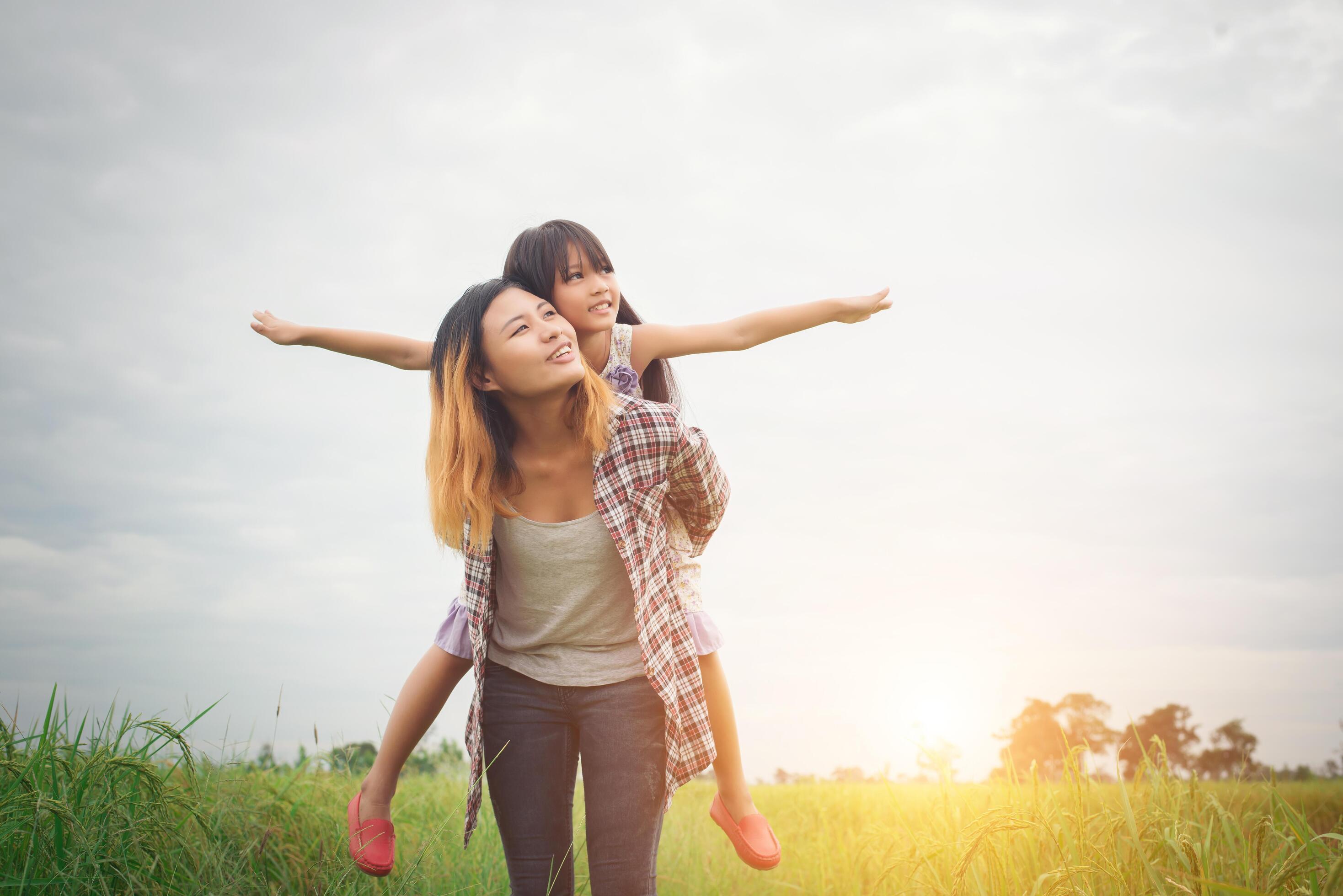 Portrait mom and daughter playing outdoor, enjoying family time. Stock Free