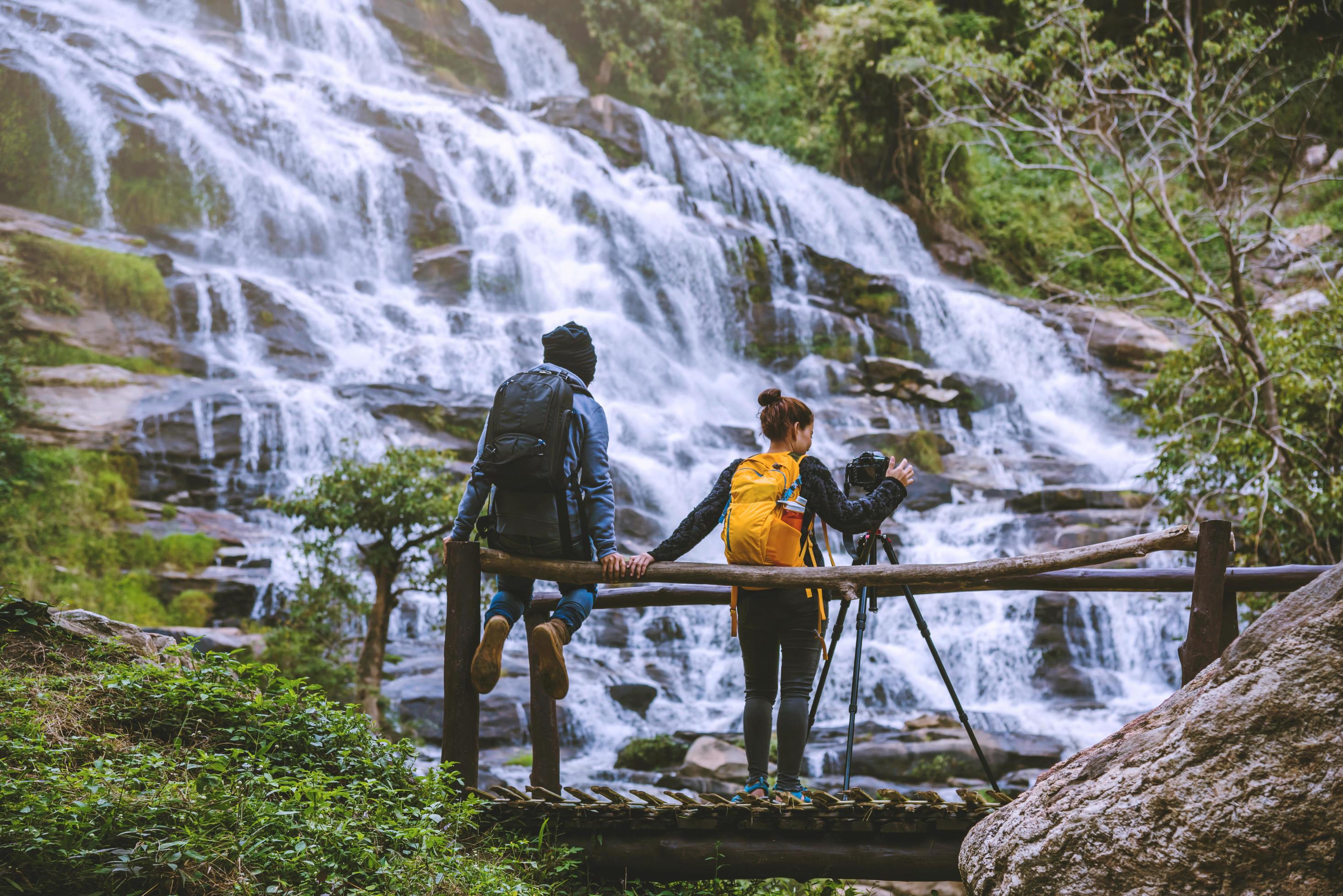 couples travel relax to photograph the waterfalls beautiful. In the winter. at the waterfall mae ya chiangmai in thailand. travel nature. summer Stock Free