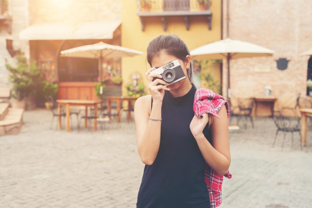 Young beautiful woman with retro camera , Vintage retro style Asian girl on vacation smiling happy. Stock Free