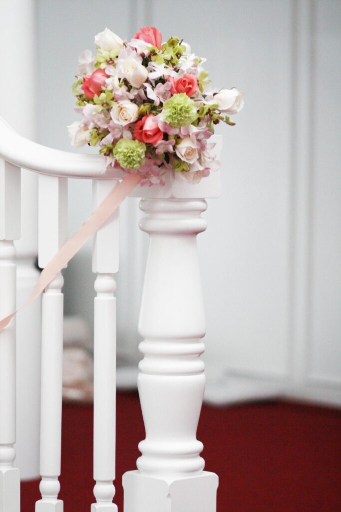 Beautiful Flowers bouquet decoration on white stair railing vintage style in wedding ceremony Stock Free