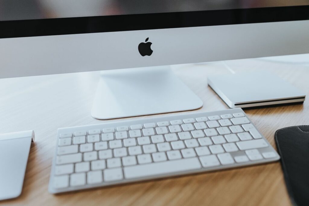 White Apple iMac computer with elephant mousepad Stock Free