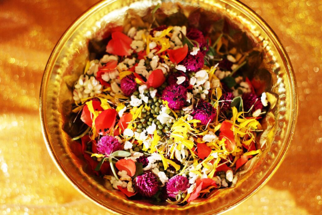 Red rose and Marigold flowers petals in gold tray in tradition Thai wedding ceremony and Buddhism in the temple Stock Free