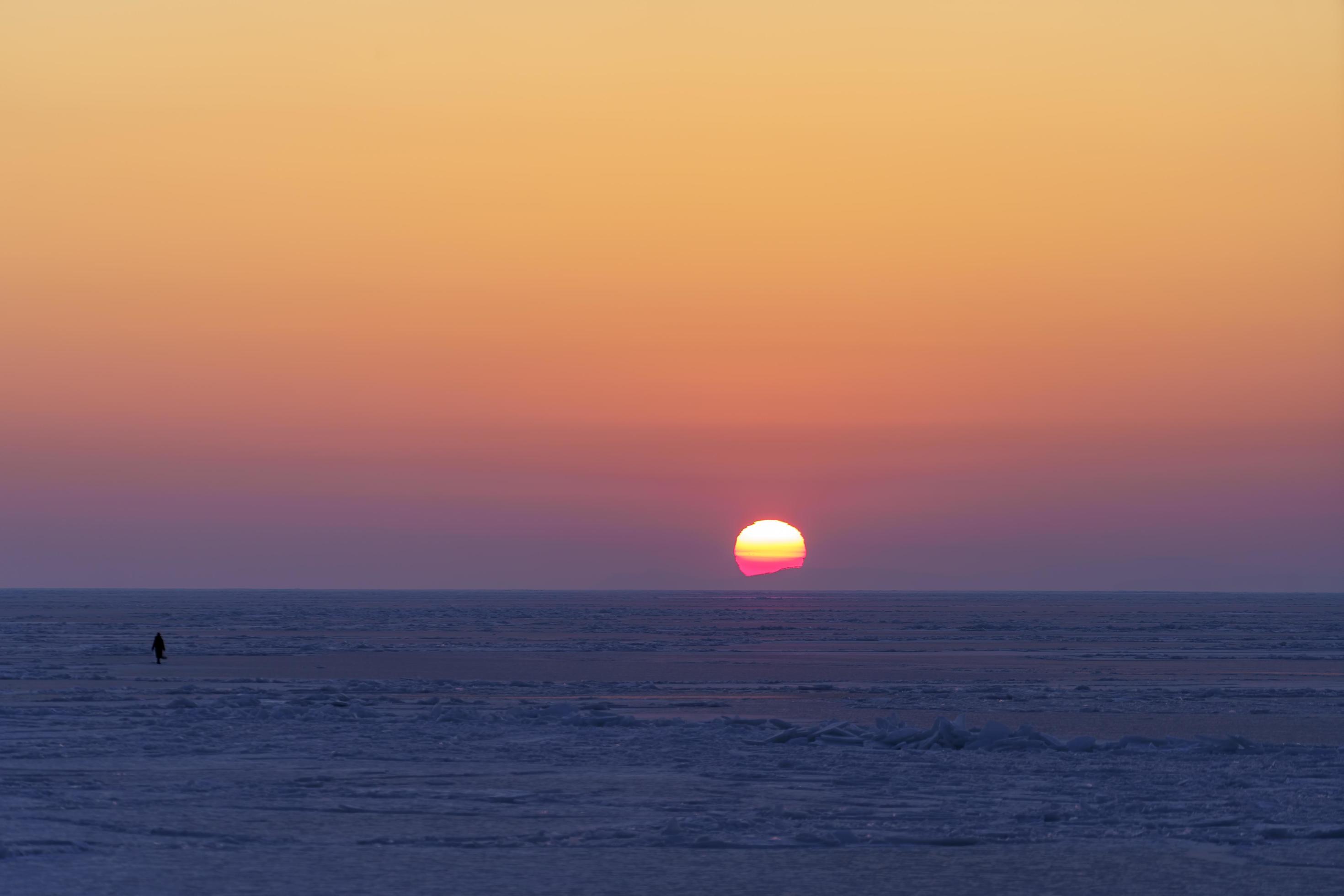 Natural backdrop with sunset over the frozen sea Stock Free