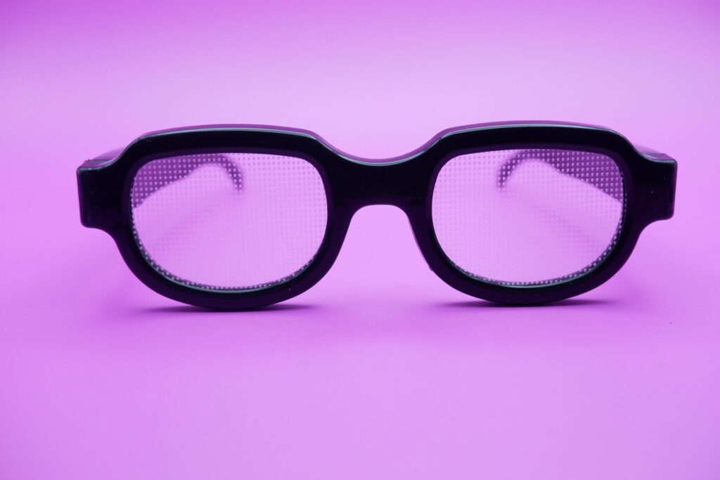 sunglasses isolated on purple background. sunglasses with curved frames and transparent glass. Stock Free