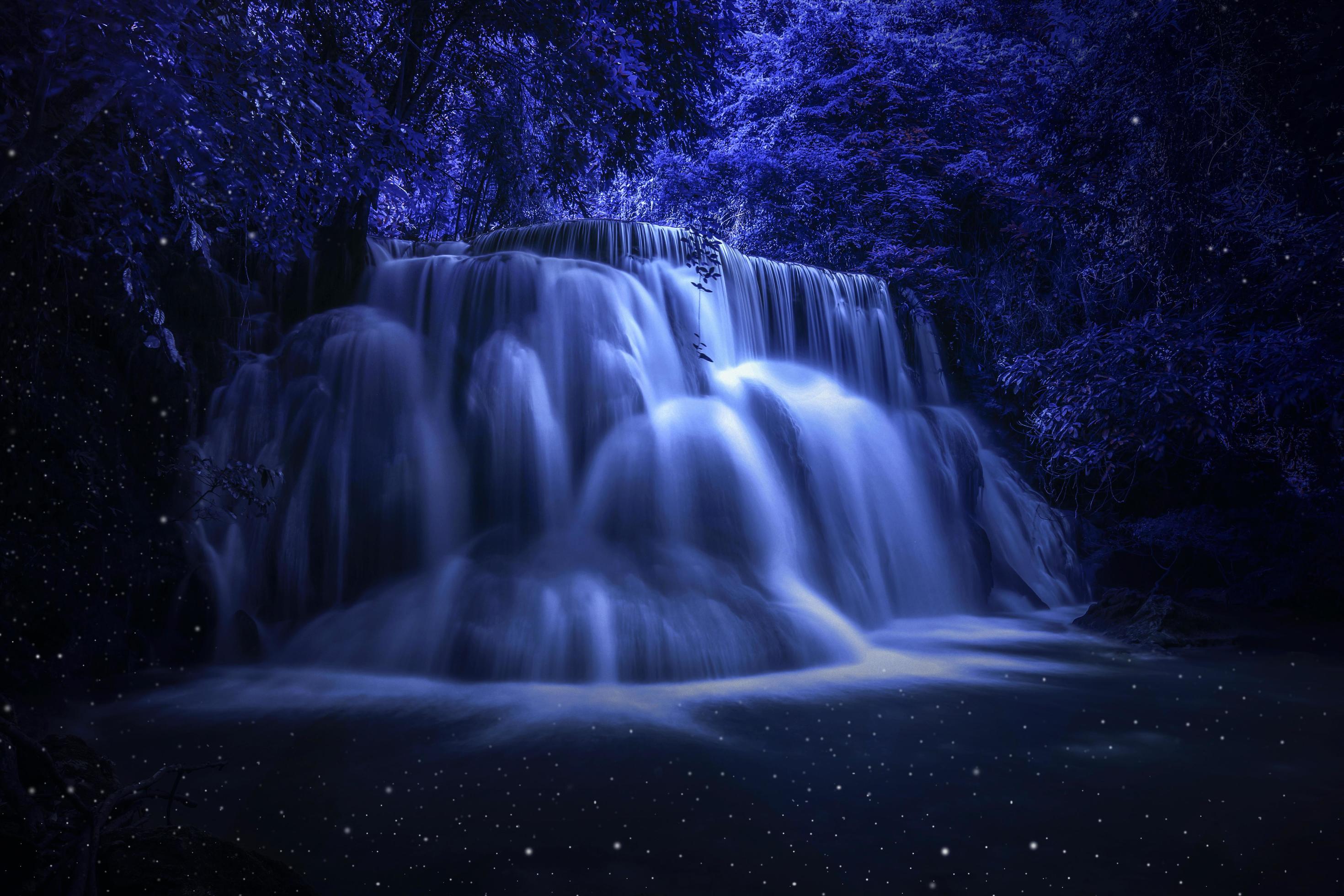 Beautiful waterfall nature scenery of colorful at a night deep tropical fantasy jungle Stock Free