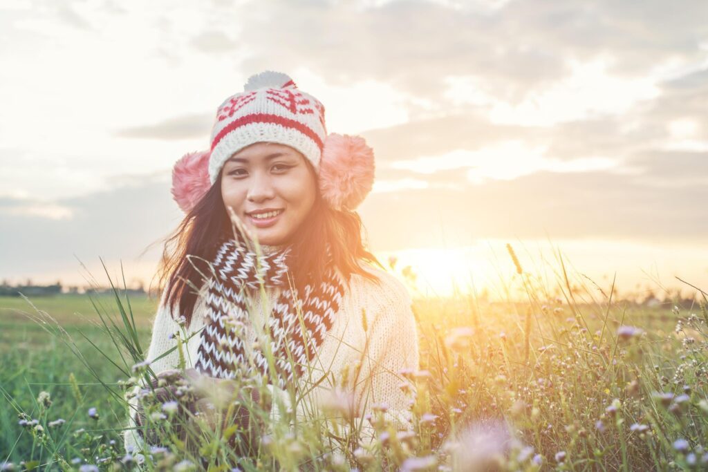 Young beautiful woman wearing winter clothing while standing enjoy with nature. Winter time concept. Stock Free