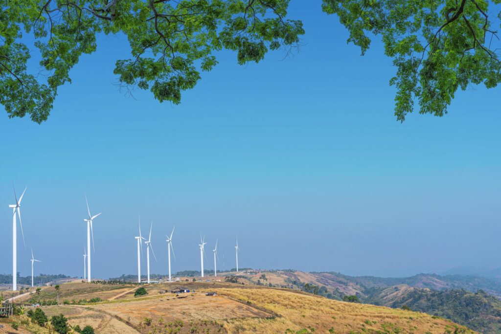 Wind turbine on the mountain with blue sky natural background. Stock Free