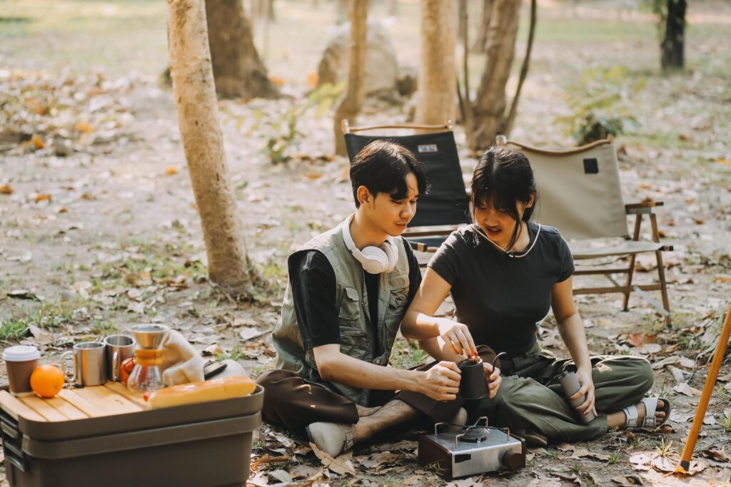 Asian couple sweet in tent inside on they camping trip, traveller relax and sleep togather in out door and camping trip Stock Free