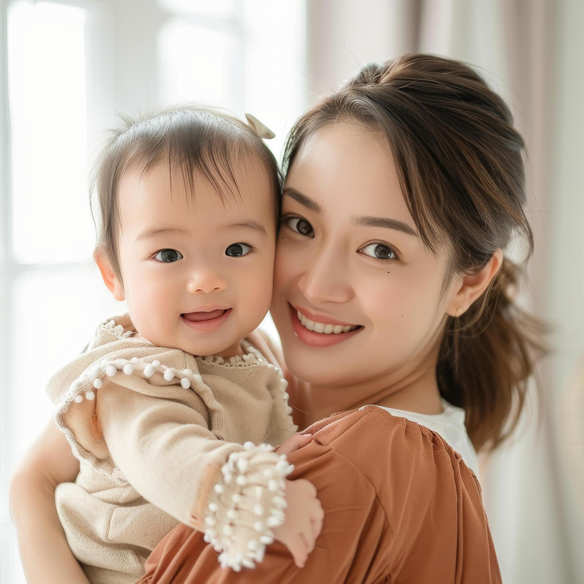 Young mother holding her baby with affection suitable for family-related content Stock Free