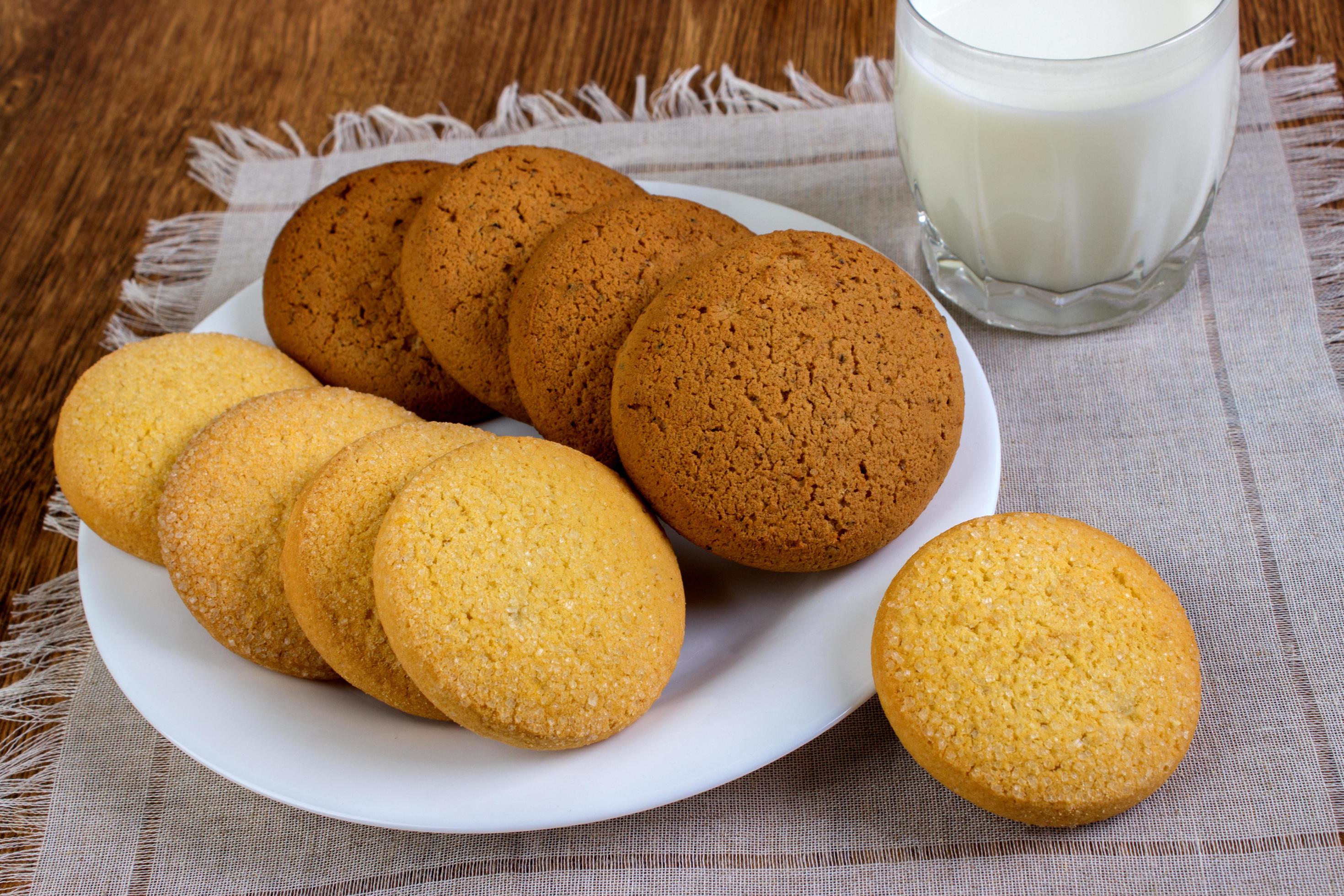 food, junk-food, culinary, baking and eating concept – close up oatmeal cookies and milk glass Stock Free