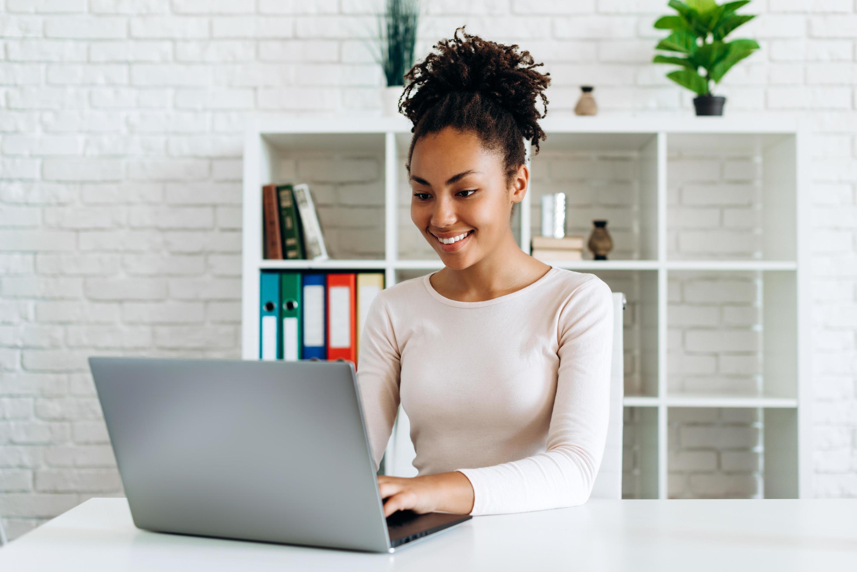 Beautiful girl working on a computer at home Stock Free