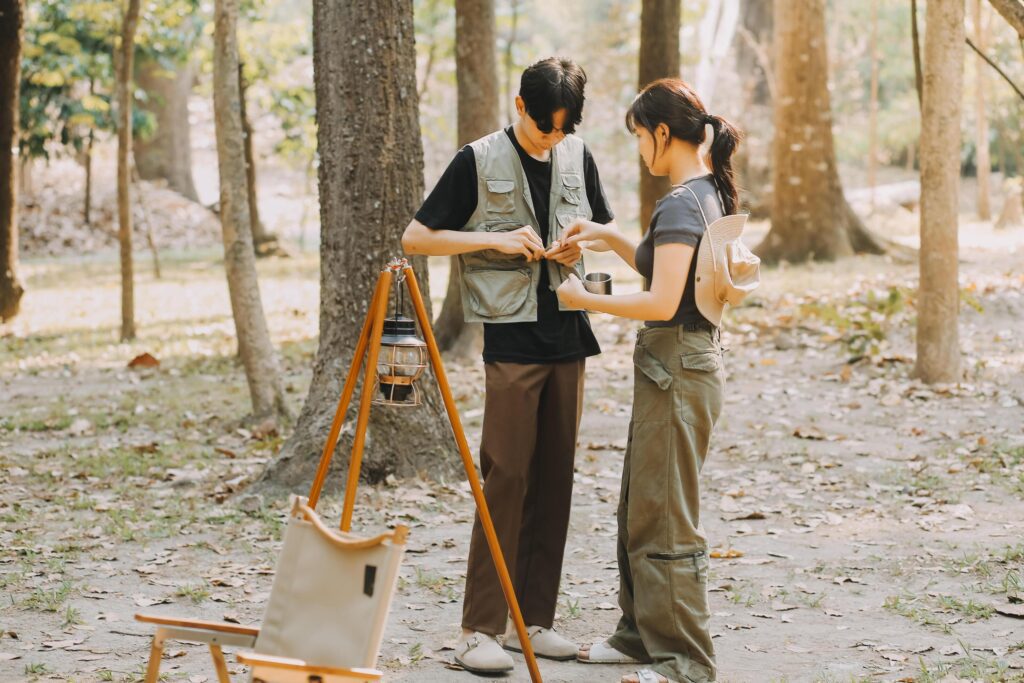 Asian couple sweet in tent inside on they camping trip, traveller relax and sleep togather in out door and camping trip Stock Free