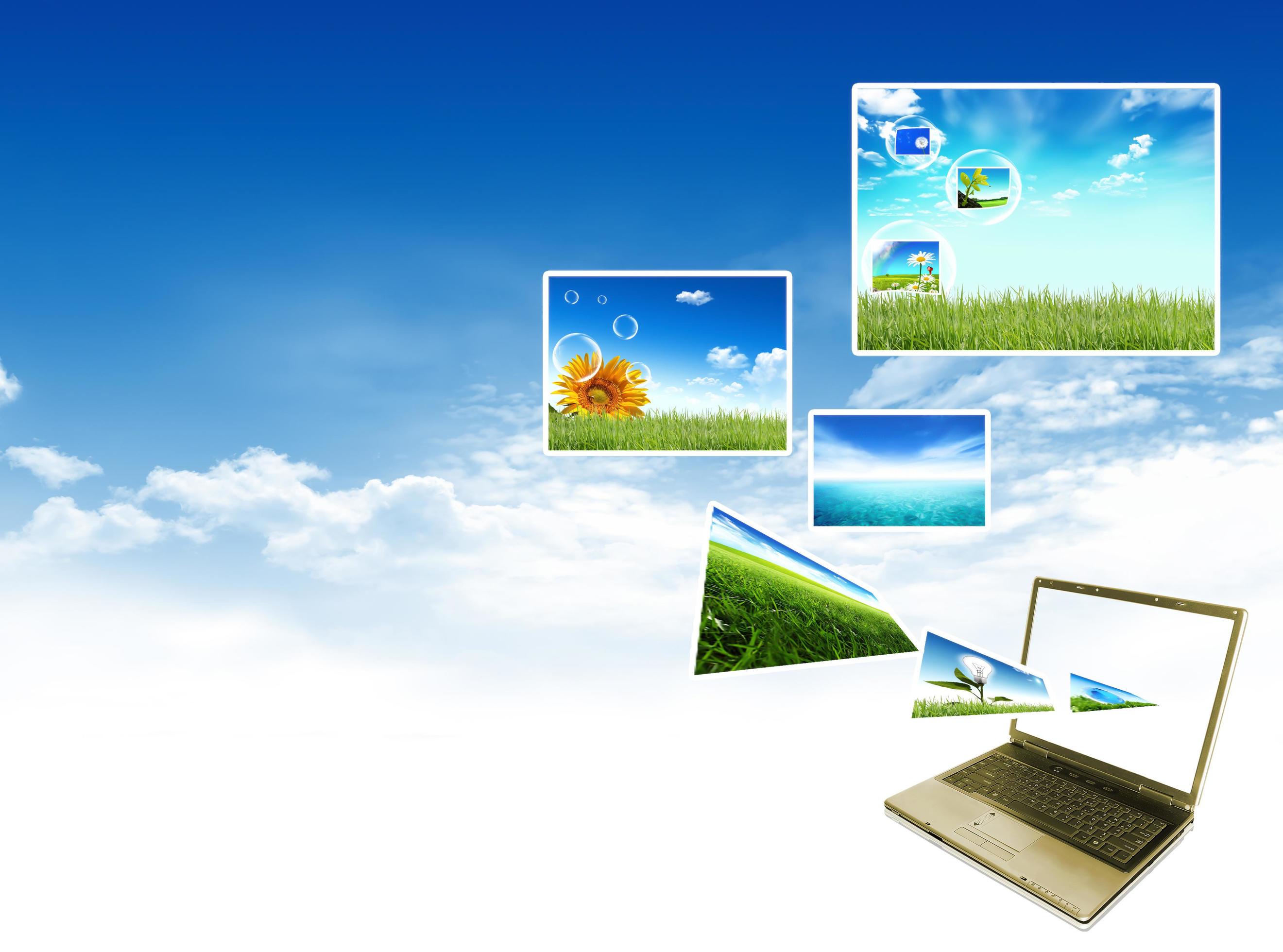 Multimedia concept with modern laptop on green field. Stock Free