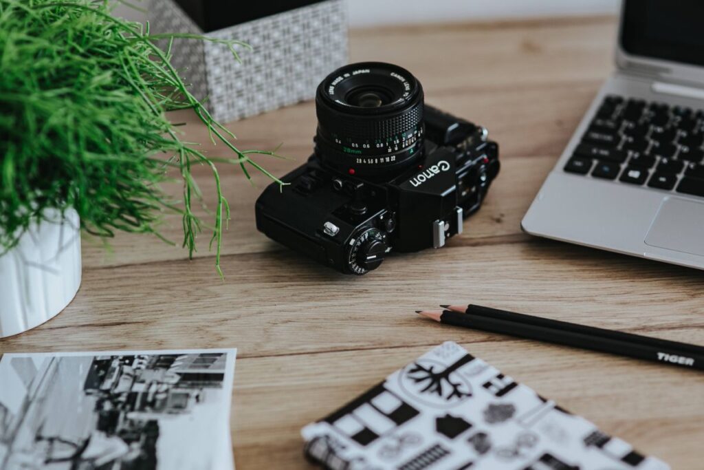 Black-and-white photos with a silver laptop, a smartphone, car keys, pencils and a camera Stock Free