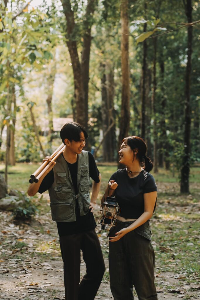 Asian couple sweet in tent inside on they camping trip, traveller relax and sleep togather in out door and camping trip Stock Free