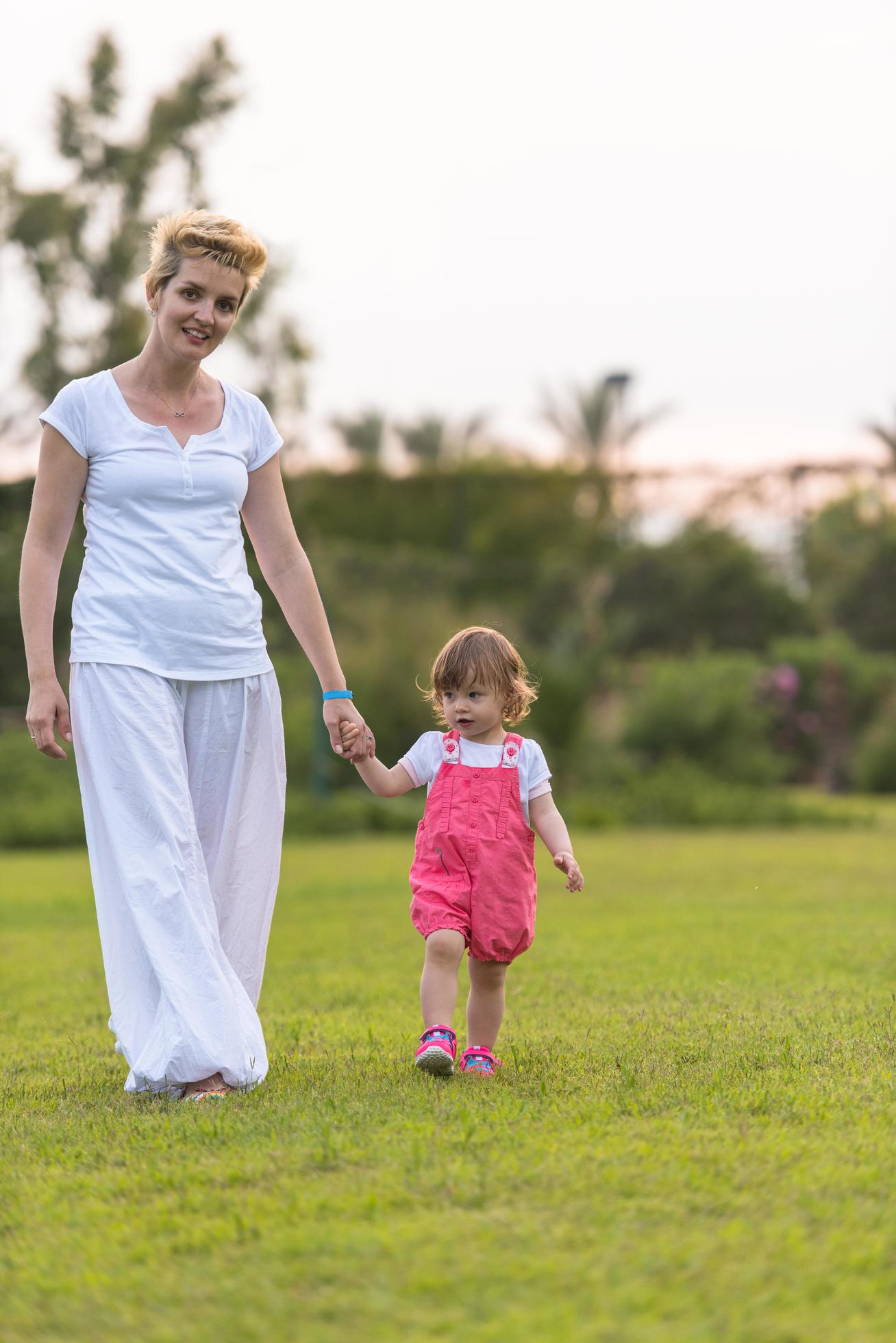 mother and little daughter playing at backyard Stock Free