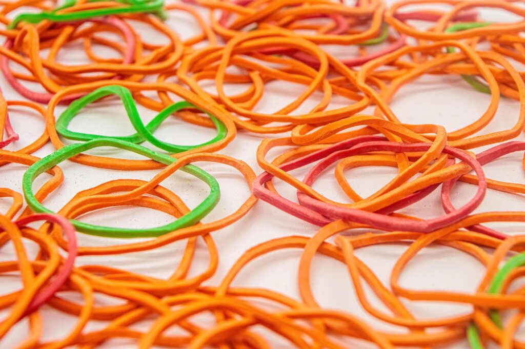 a bunch of messy rubber bands on a white background Stock Free