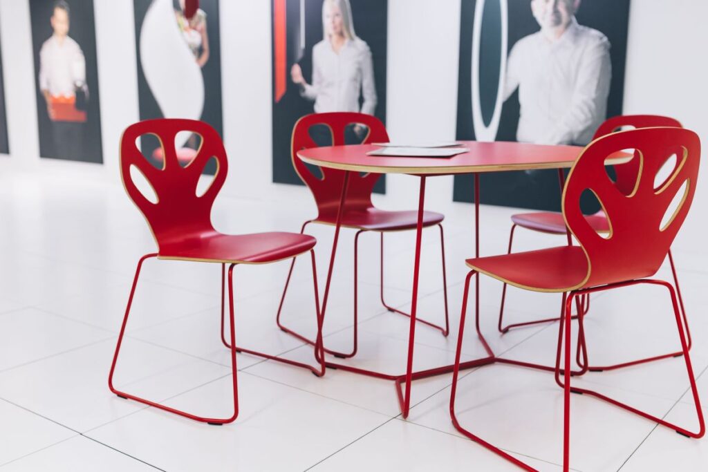 
									Collection of chairs and tables arranged at a design exhibition Stock Free