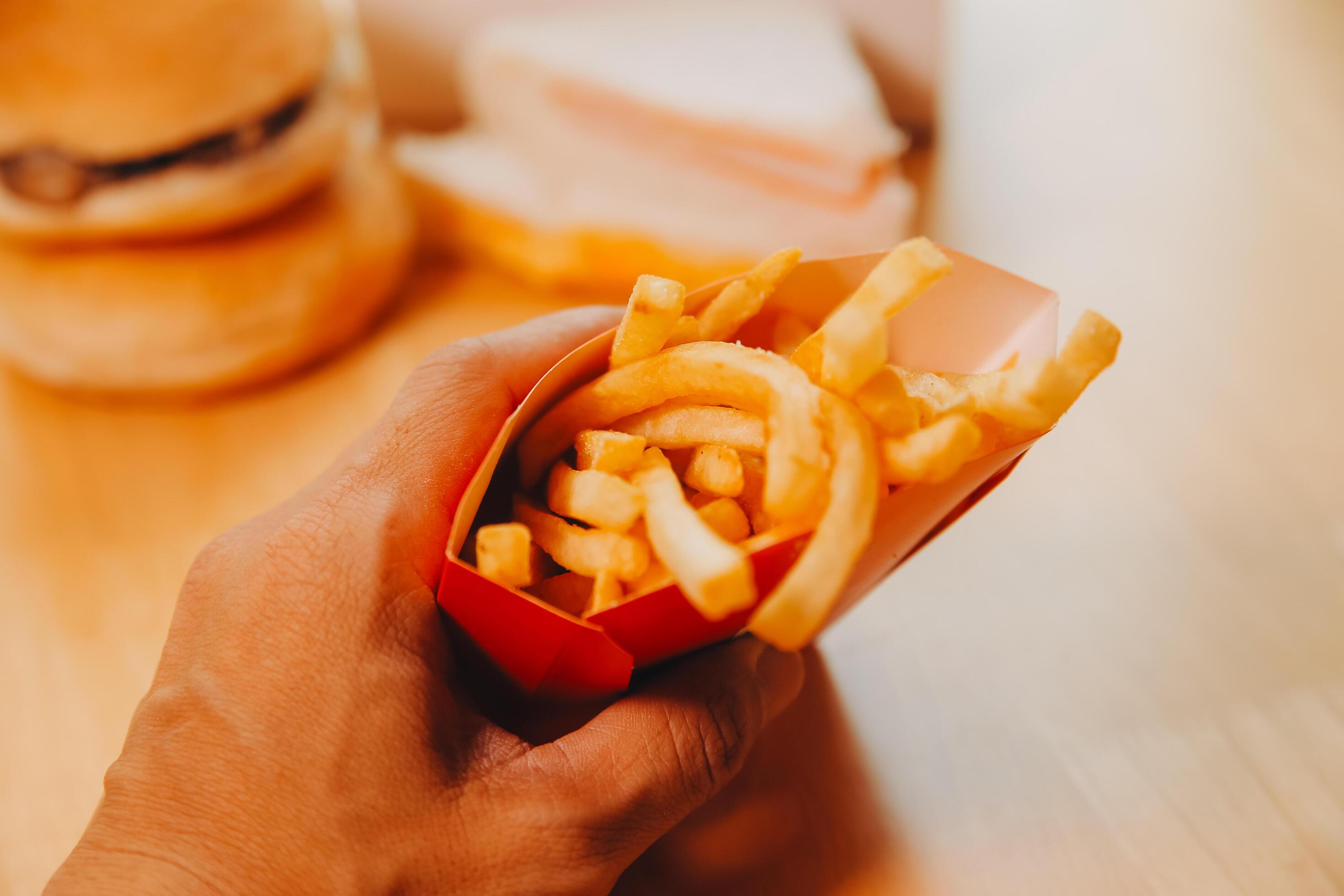 Fresh fried french fries with ketchup on wooden background Stock Free