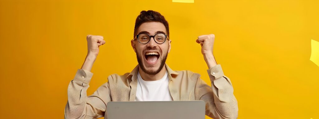 Elated Young Business Professional Celebrates Success at Work with Laptop Stock Free