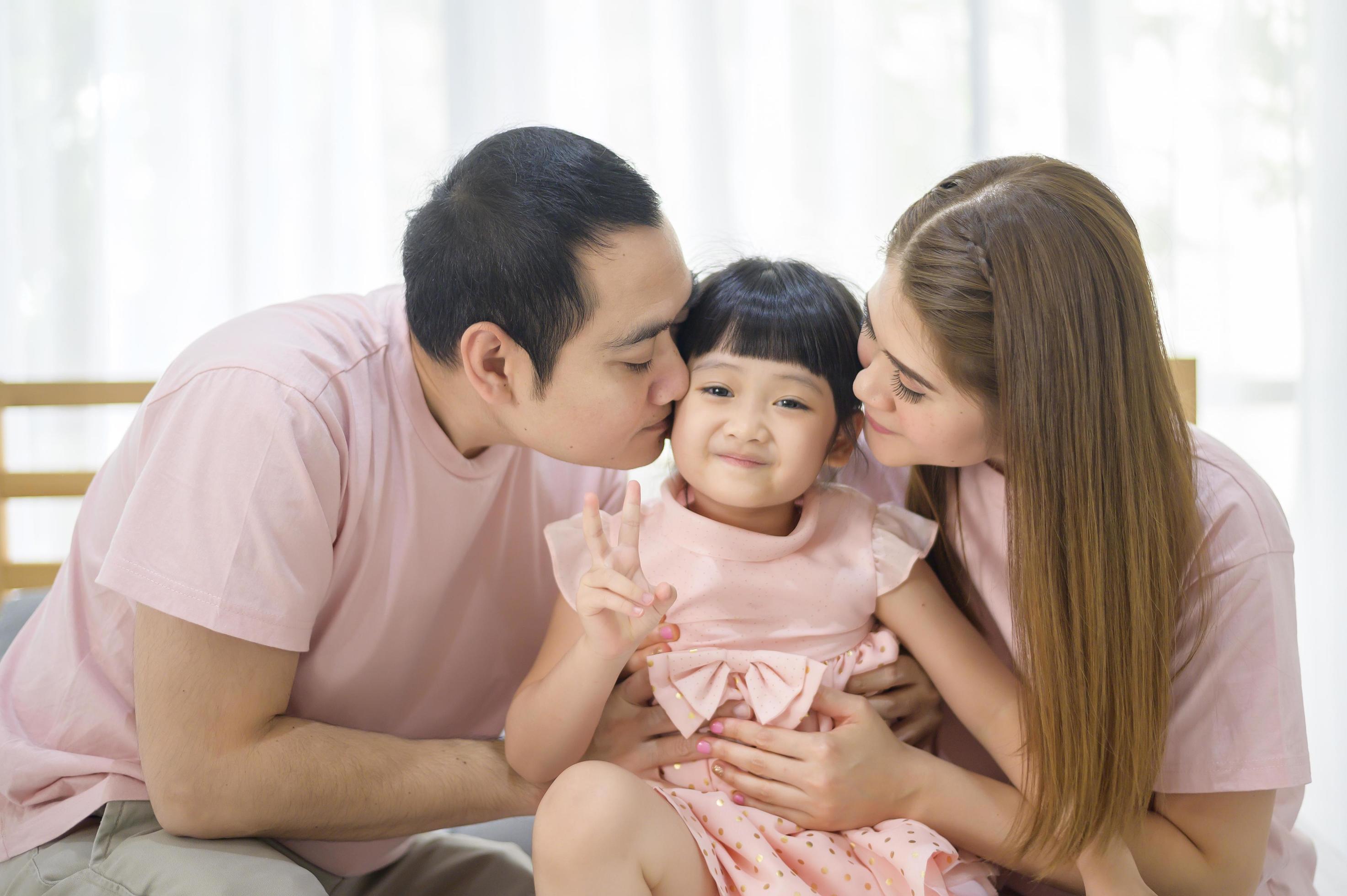 portrait of happy Asian family in white bedroom Stock Free