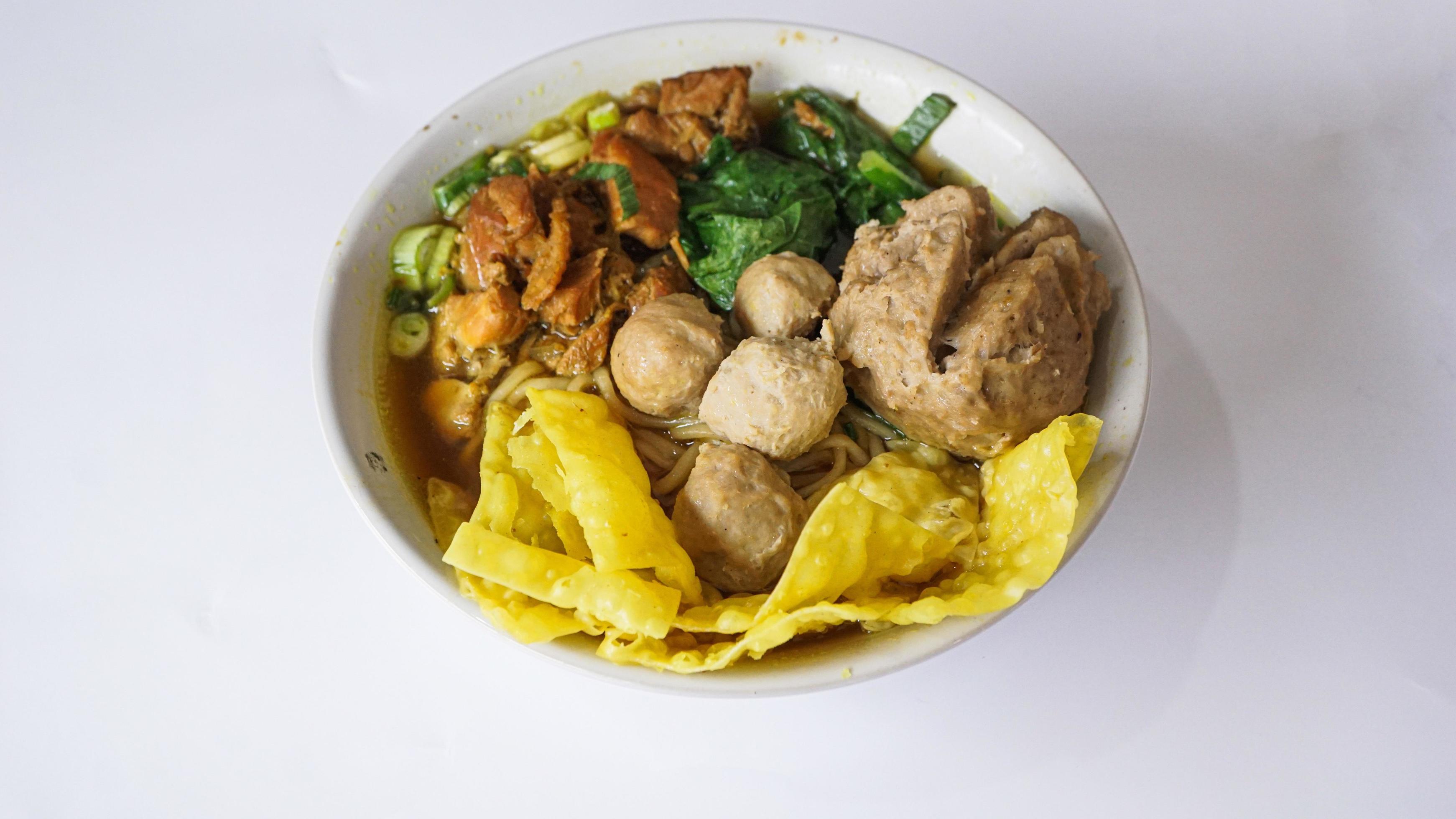 Mie Ayam or Bami ayam, top view noodles with chicken and served with meatballs and deep-fried wonton pangsit Indonesian food, Stock Free