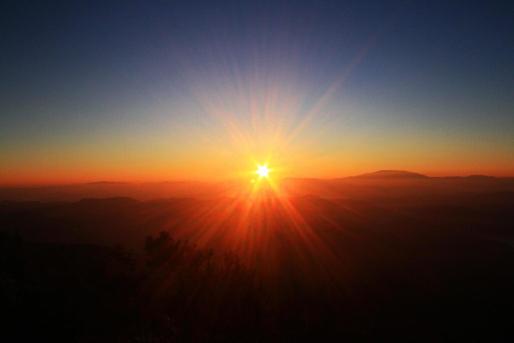 Beautiful golden natural sunlight and twiligh of sunrise shining to in the mist on valley of mountain in Thailand Stock Free