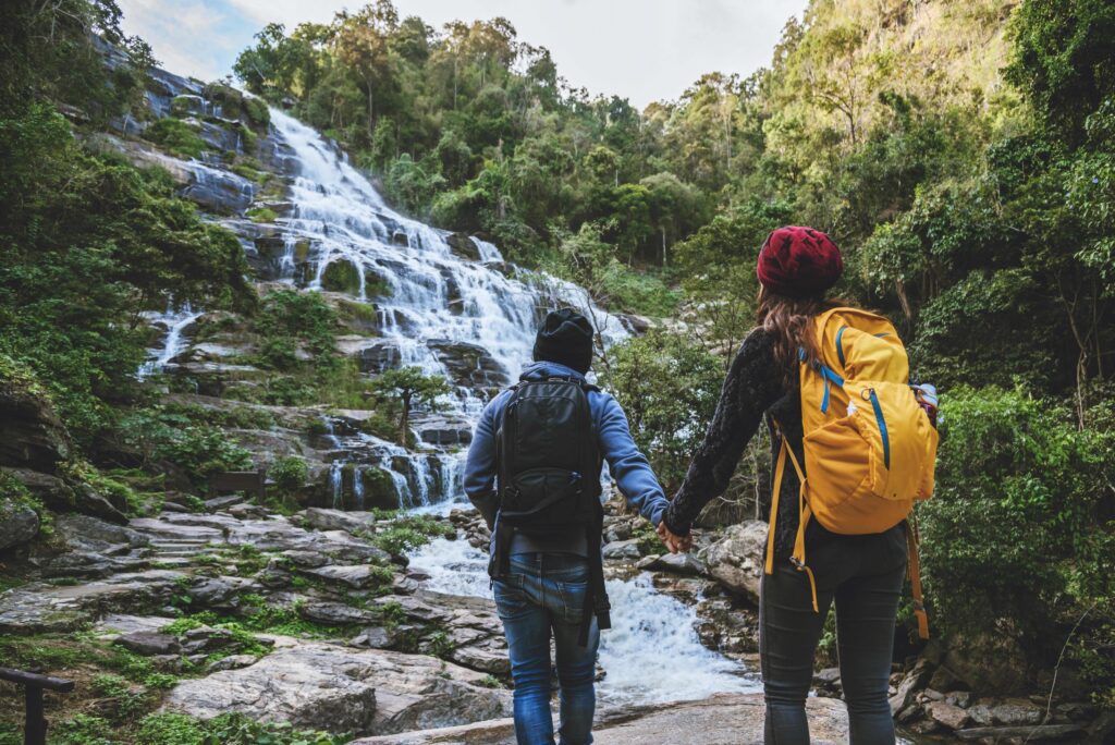 Travel relax to visit the waterfalls of couples. In the winter. at the waterfall mae ya chiangmai in thailand. travel nature. summer Stock Free