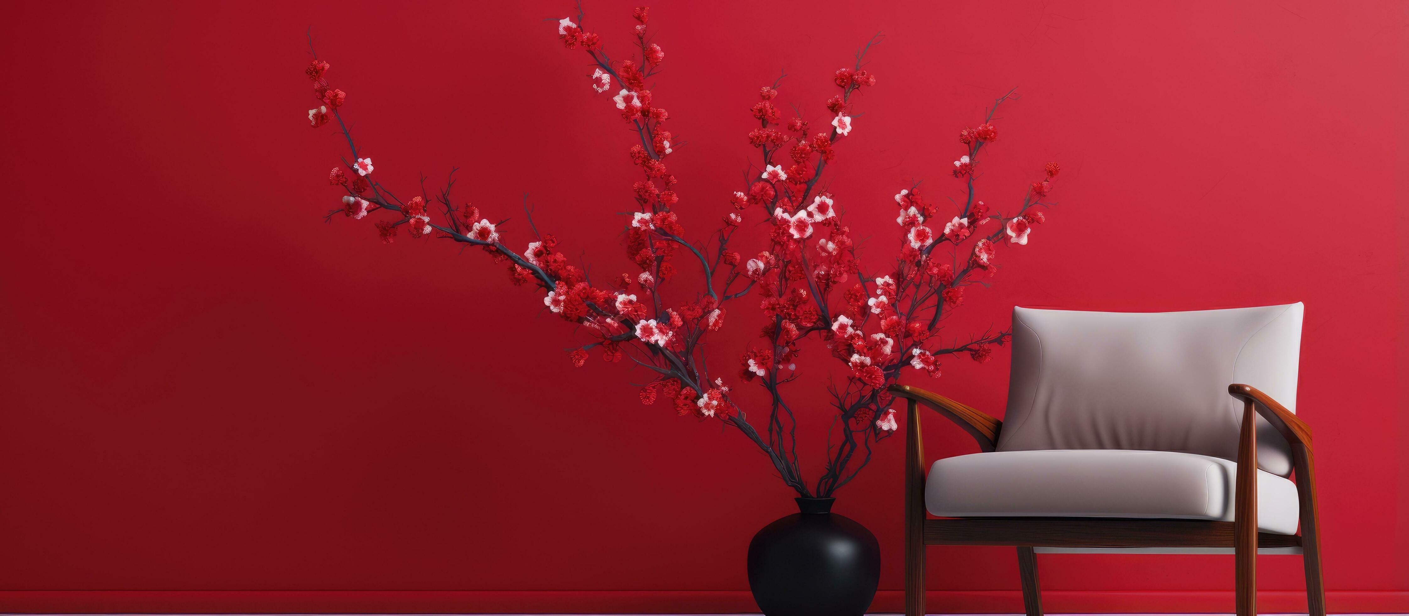 Armchair next to red wall with flowering Chinese plum branches indoors Stock Free