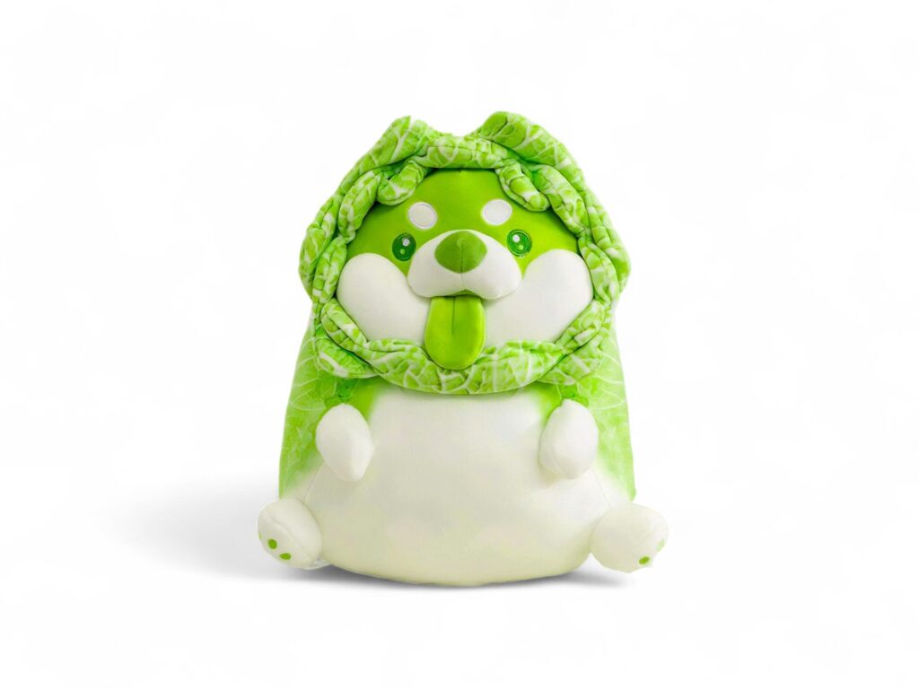 Cute stuffed dog animal character in a cabbage costume on a white background Stock Free