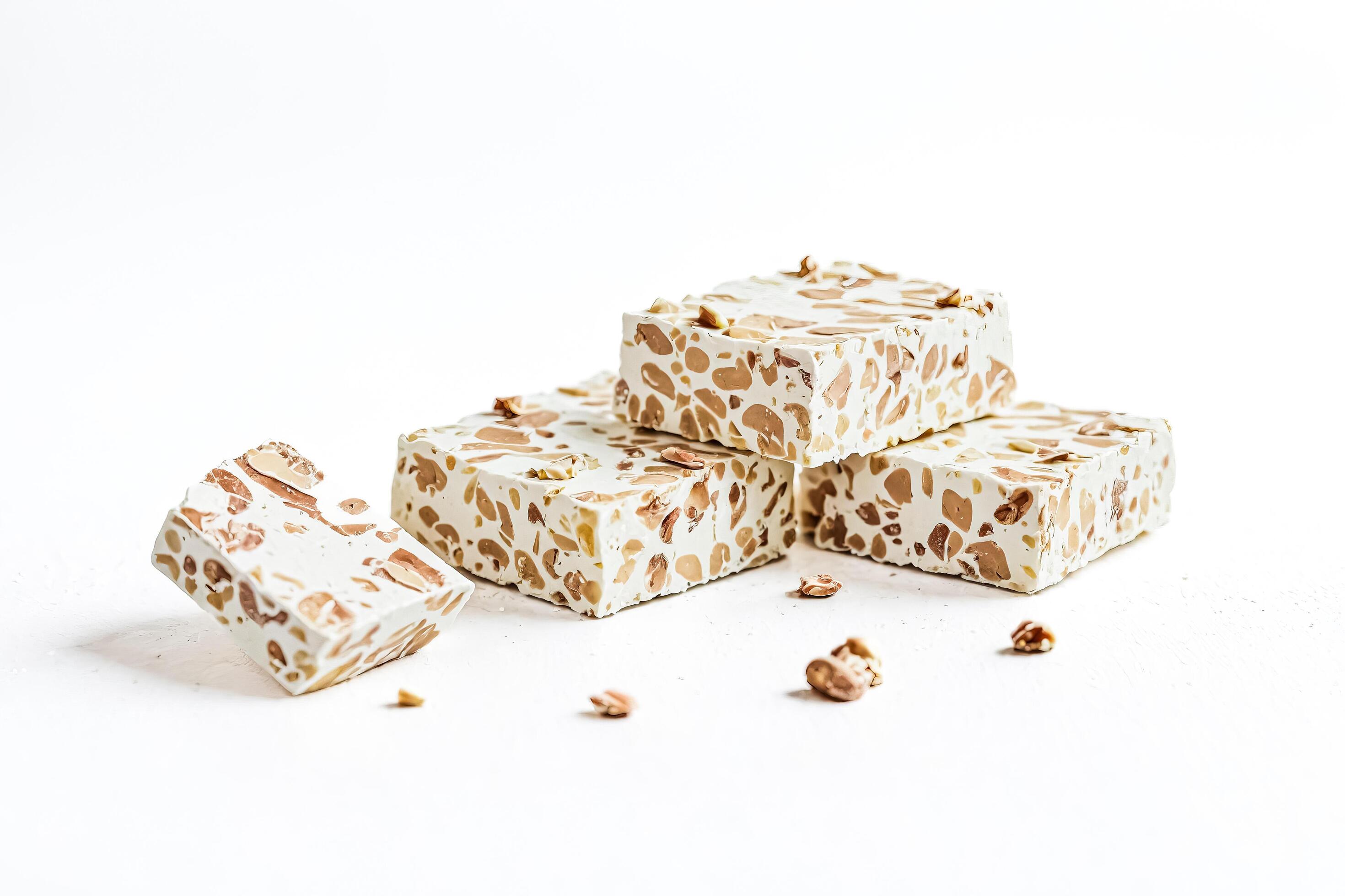 Stacked nougat with almonds on white background Stock Free