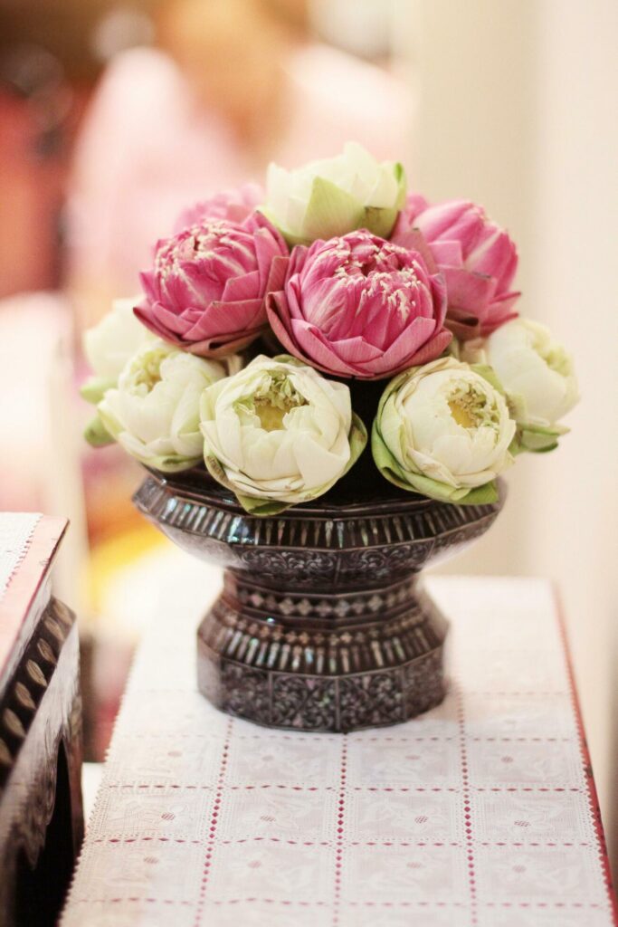 Beautiful pink lily and lotus flowers decoration on Engagement bowl for pray Buddha statue.Thai wedding culture tradition. Stock Free