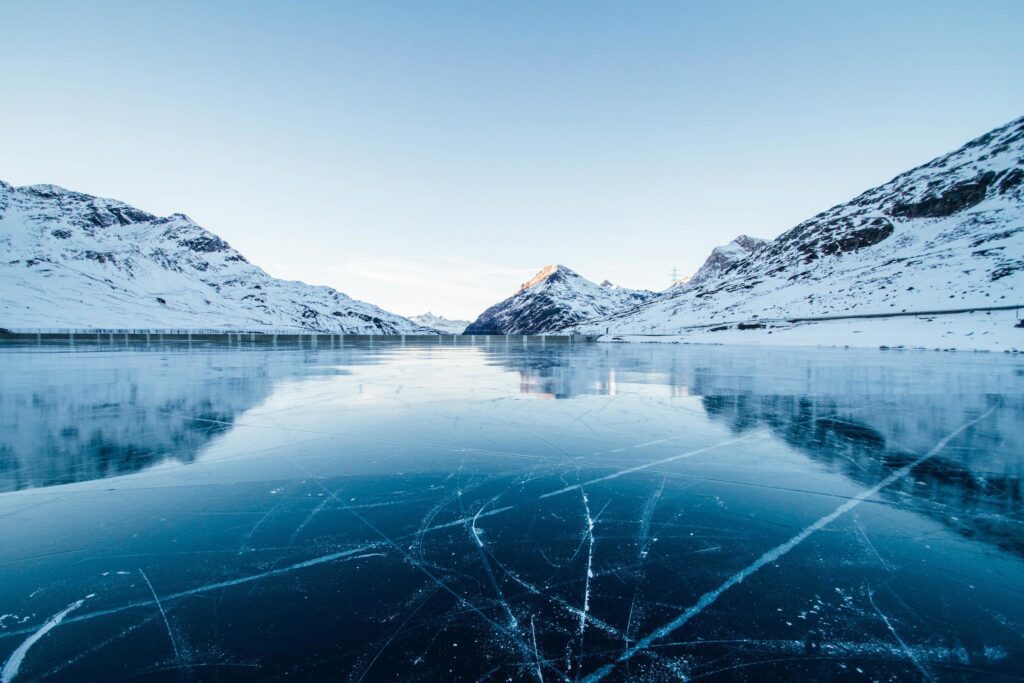 Frozen river with snow covered mountains Stock Free