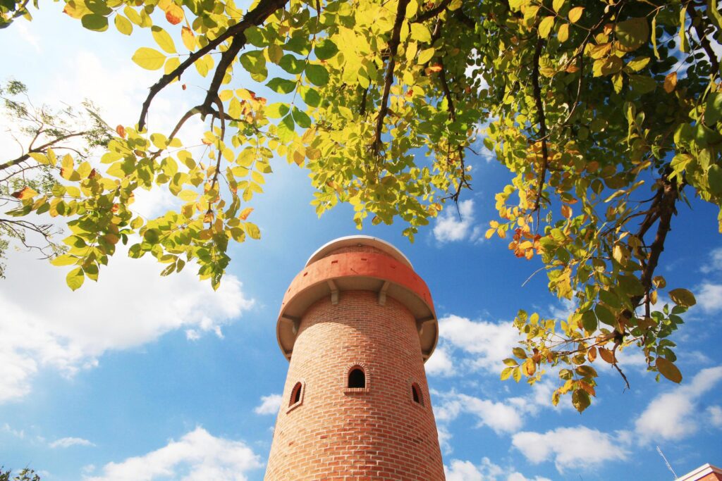 Beautiful brick stone tower is architecture roman stytle landmark in the garden and park at Thailand. Stock Free