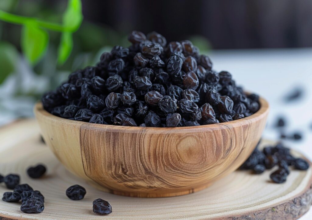 Black raisins in wooden bowl generated by AI. Free Photo