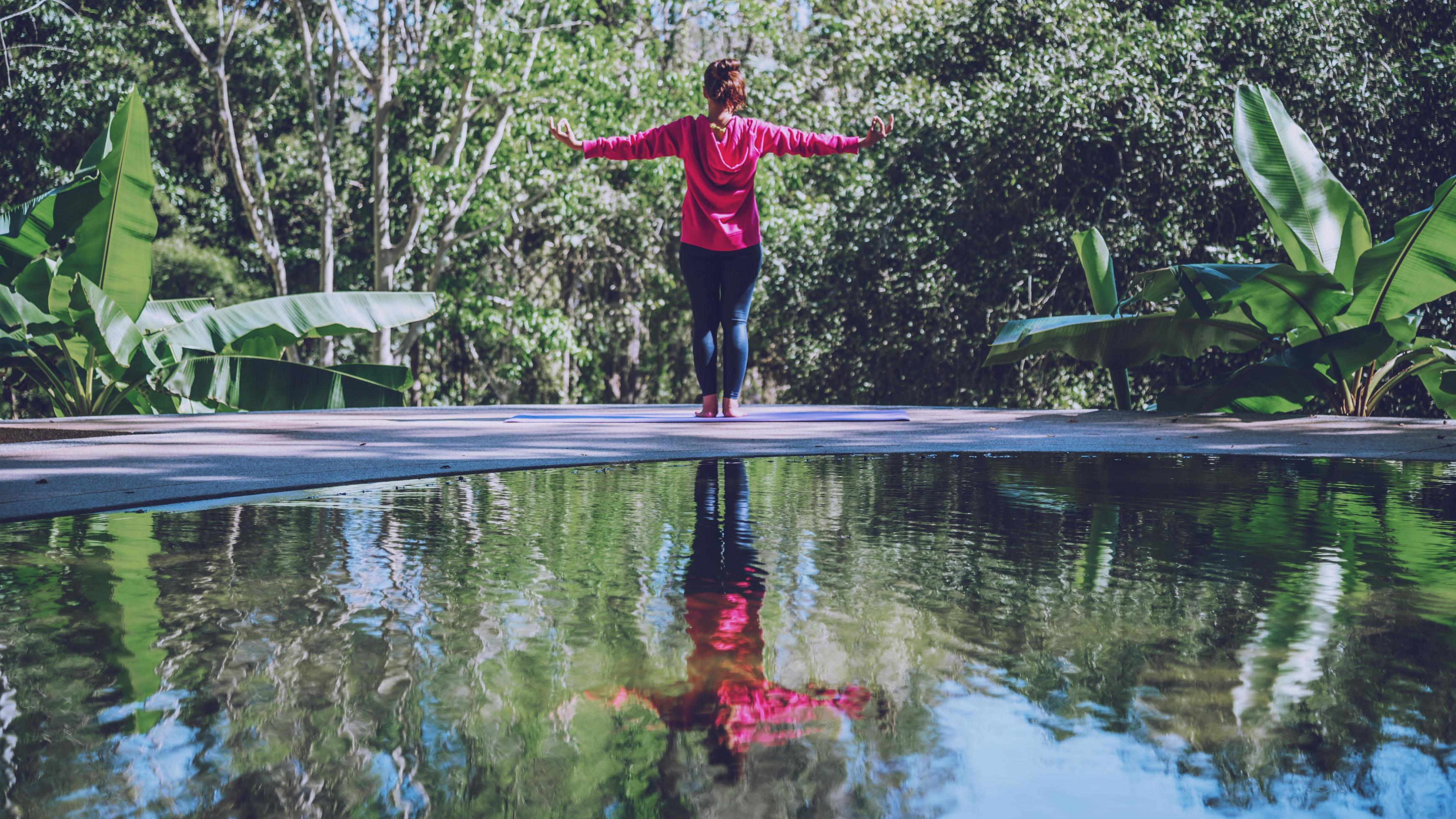 Young girl standing relaxing body, yoga exercise. Hot Springs In National Park,Hot Spring nature travel,Relax and exercise at the pool. Stock Free