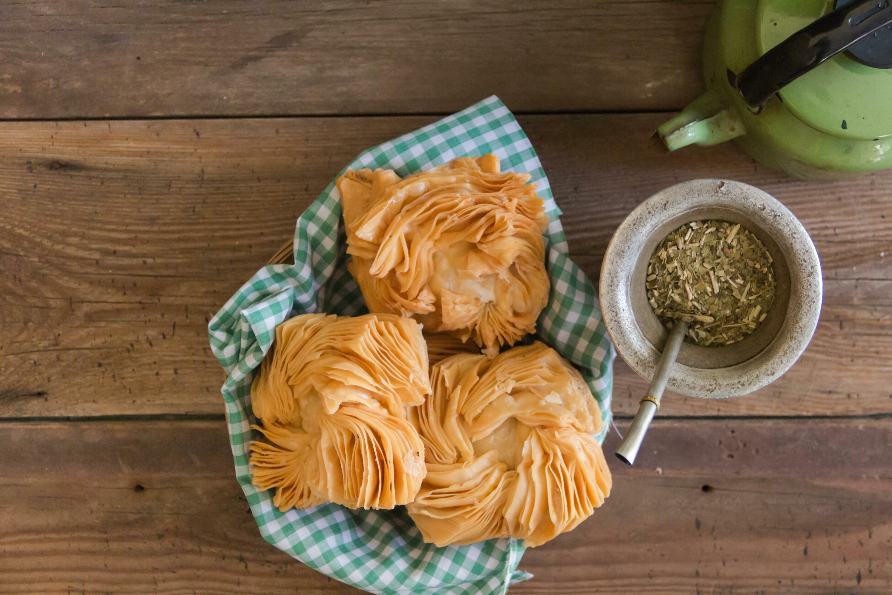 top view of yerba mate infusion with fried quince and sweet potato cakes. Typical food in the Argentine patriotic days Stock Free