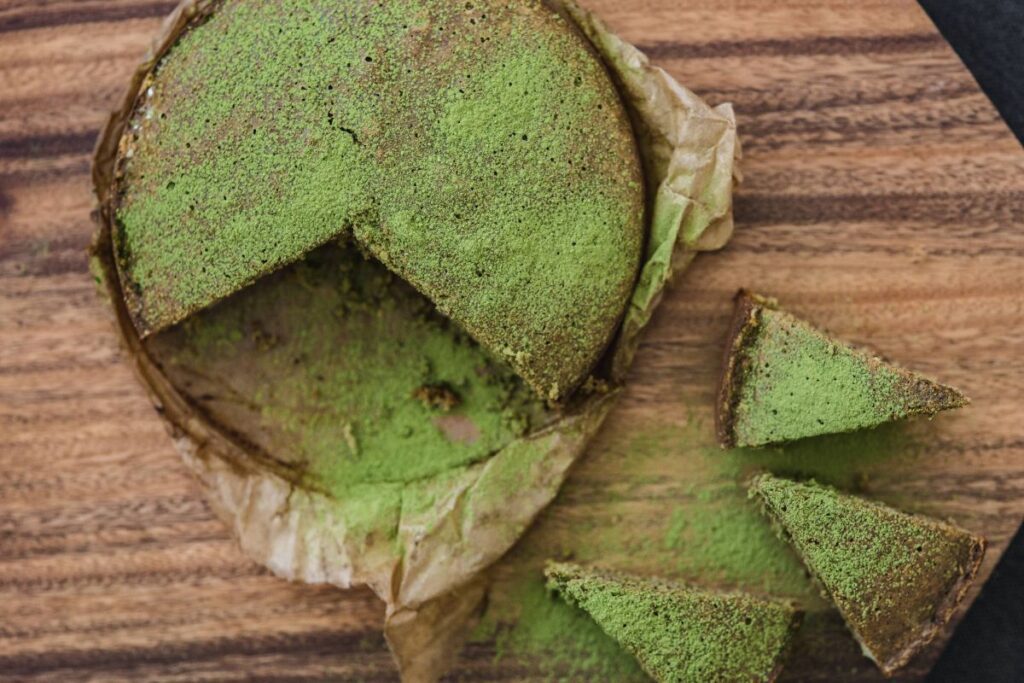 Delicious homemade matcha cake on a wooden board Stock Free