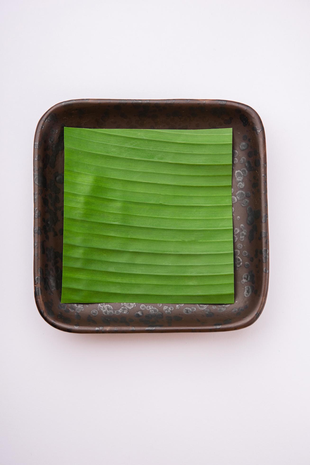 banana leaf on blank plate for edit food or subject on Stock Free