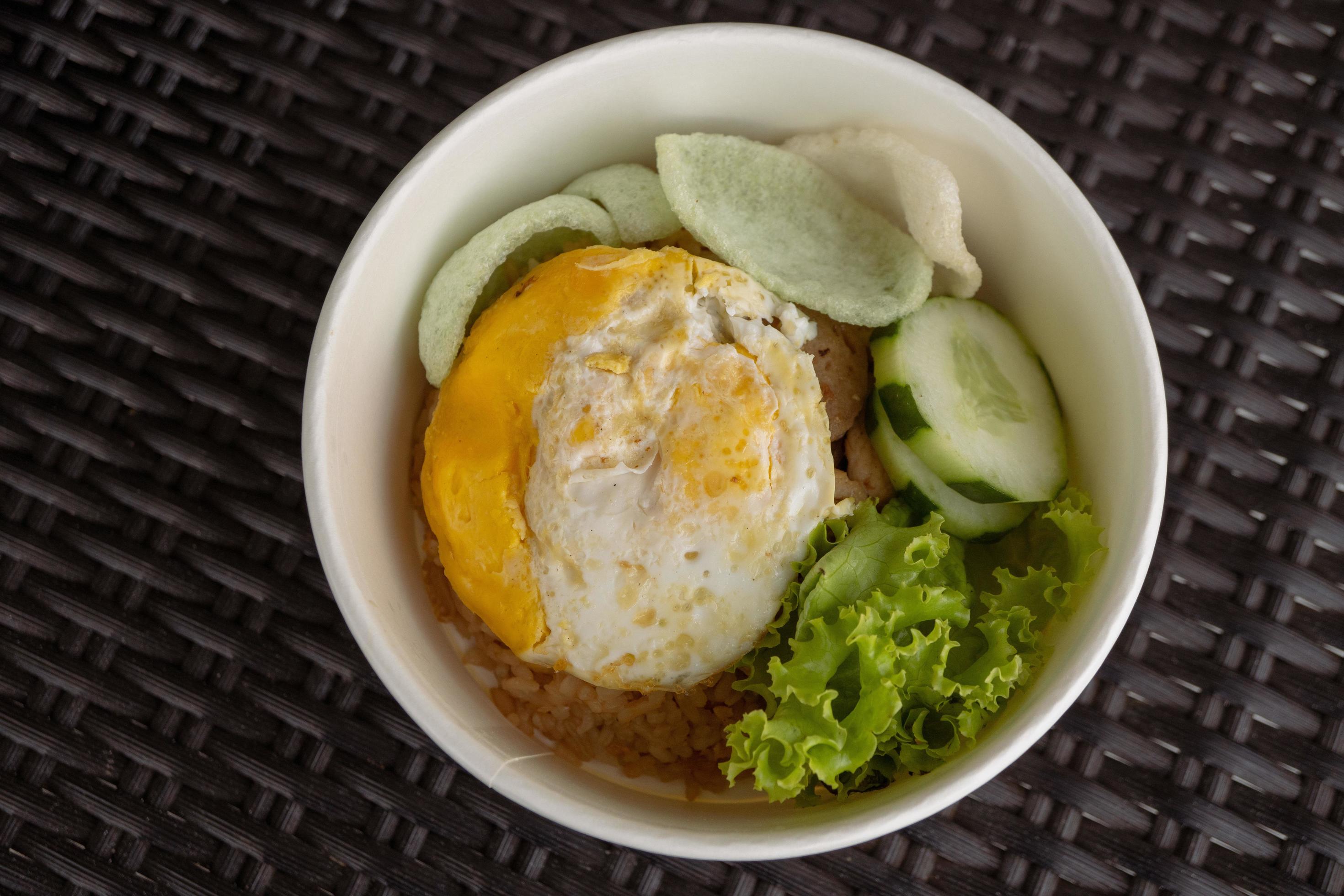 Close up photo fried rice with eggs and lettuce. The photo is suitable to use for traditional food background, poster and food content media. Stock Free