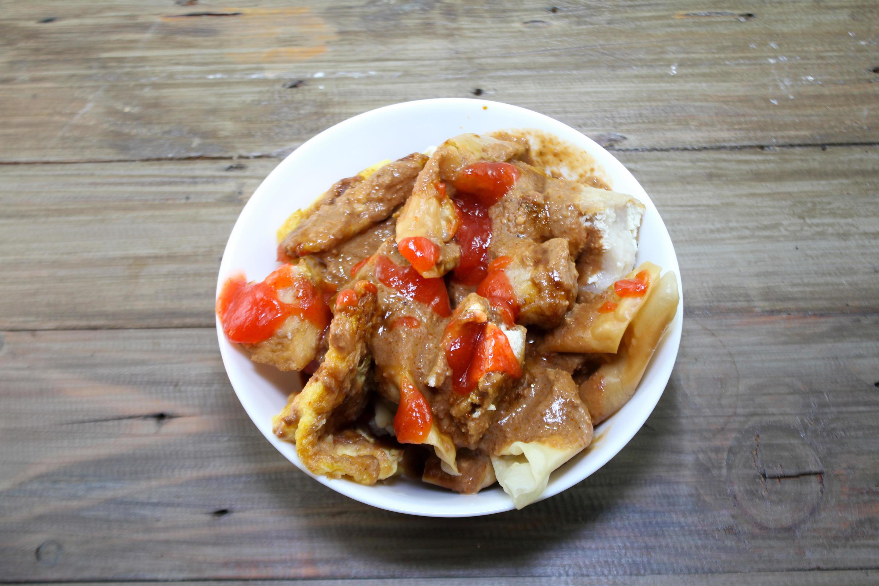 fried batagor on a white bowl. batagor is an Indonesian snack food, usually enjoyed with the addition of peanut sauce, soy sauce and chili sauce. Stock Free