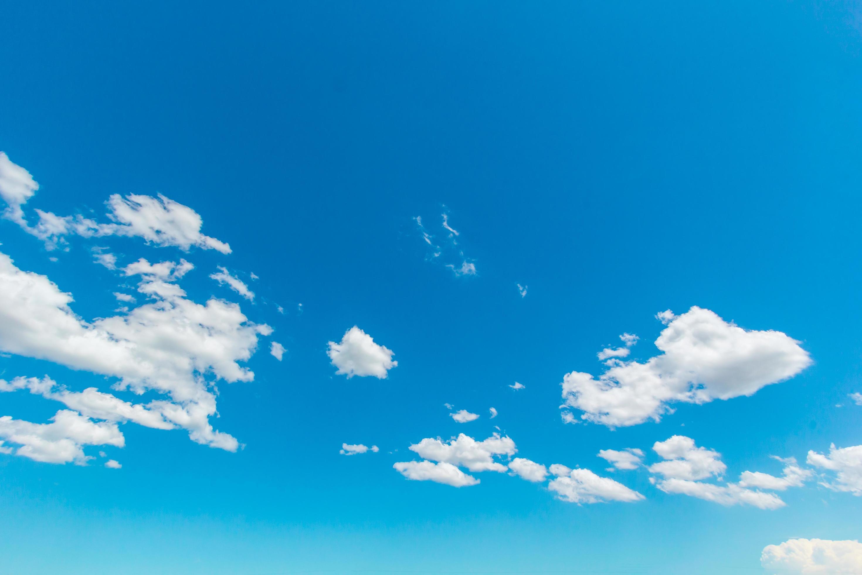 Natural abstract background of bright blue sky and fluffy white clouds on a sunny. Stock Free