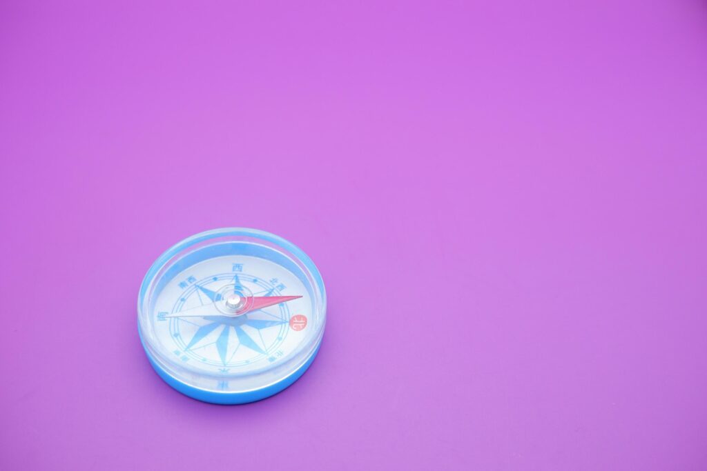 round compass isolated on purple background. Stock Free