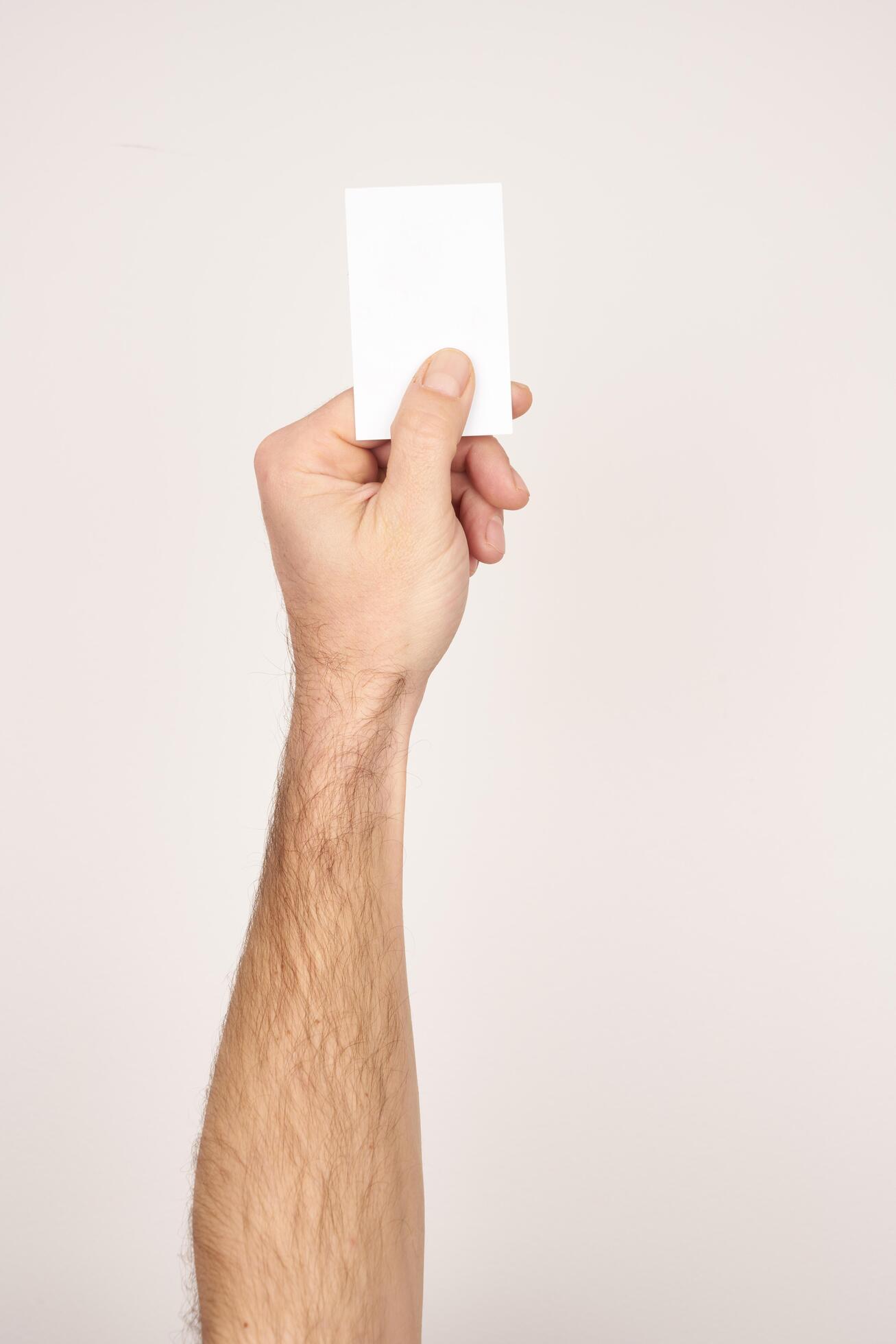 Male hand holding and giving a white blank business card Stock Free